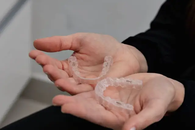 Sample stock photo: clear aligners in hand