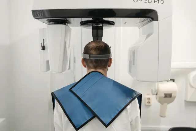 Patient standing in a 3D dental scanner