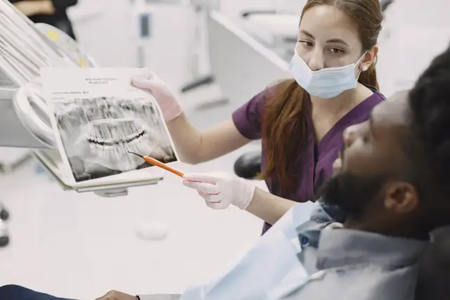 Dentist explaining a dental X-ray to a patient